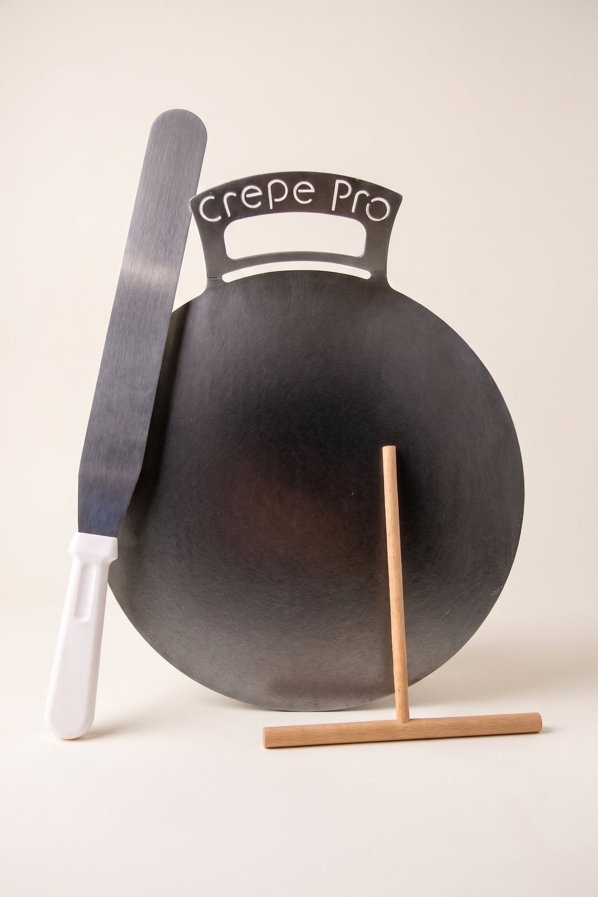 The Crepe Pro 12-inch Carbon Steel Bundle Kit with 12-inch bent-handle pan, 7-inch beechwood batter spreader, and 14-inch stainless steel spatula