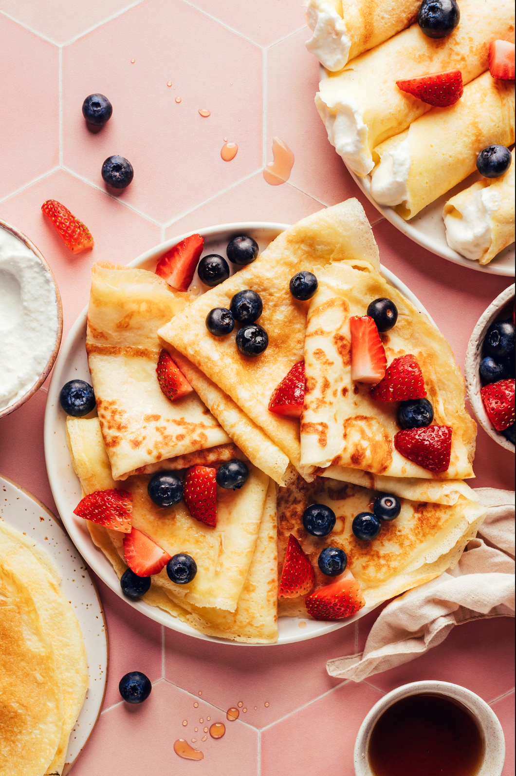 Elegant cream and fresh berry crepes served on a plate