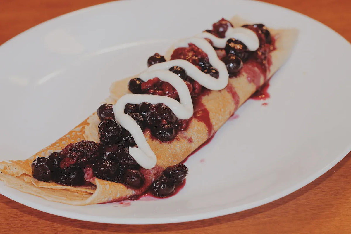 Folded raspberry crepes dusted with powdered sugar